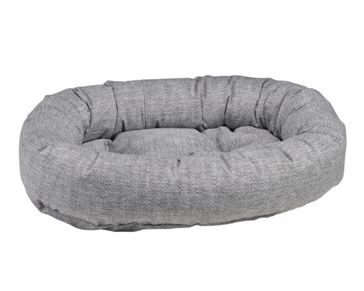 Donut Bed with oval bolster and tufted cushion in Allumina fabric.