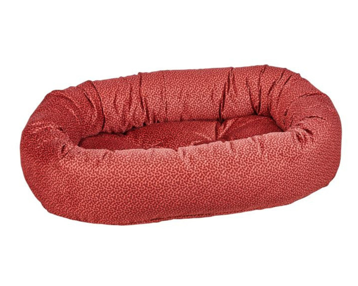 Donut Bed with oval bolster and tufted cushion in Cherry Bones.